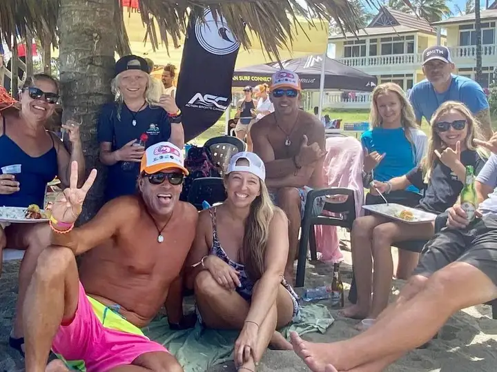 Families laughing together at a beachside lunch