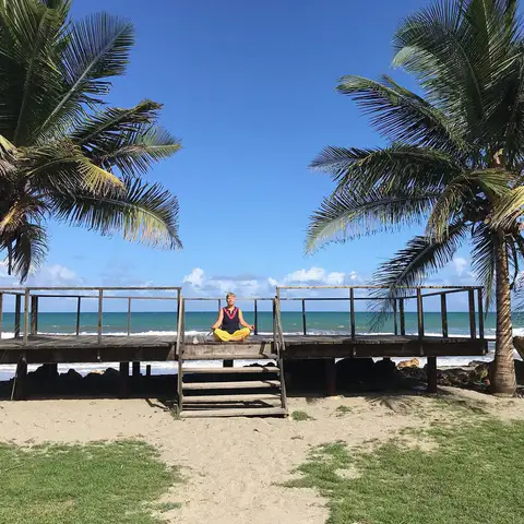 Person meditating alone on the ocean deck
