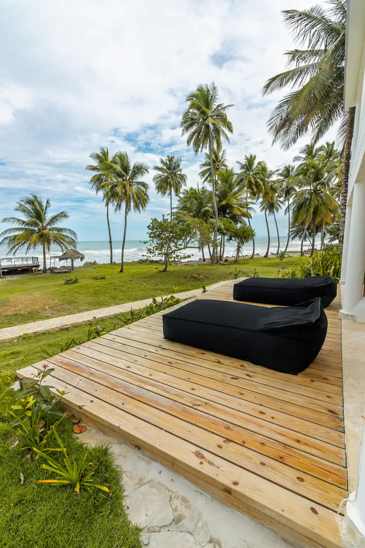Wooden ocean deck with lounge beds beside a Las Canas suite