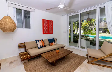 Poolside suite living room with a daybed sofa and glass doors to the pool