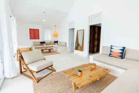 Bright open living area with lounge chairs and a coffee table