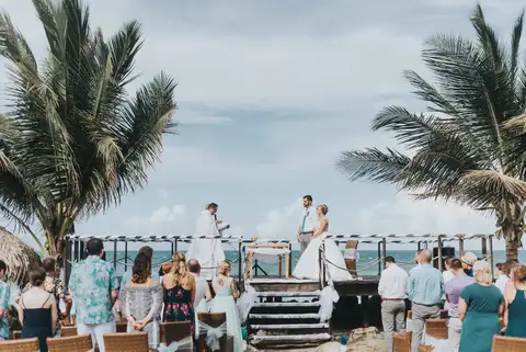 Wide view of the ceremony on the deck with palm trees