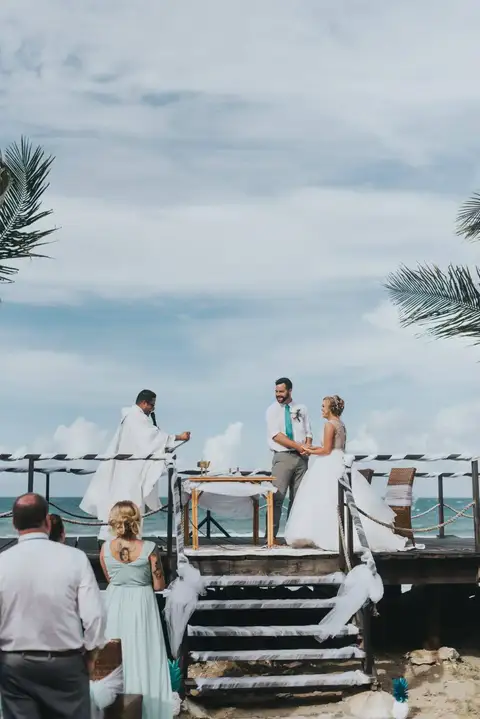 Couple at the altar with guests watching from the steps