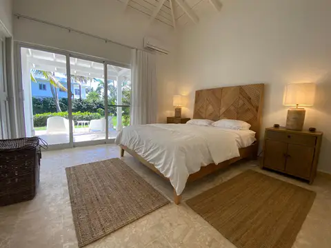 Villa bedroom with a double bed and sliding doors to the garden