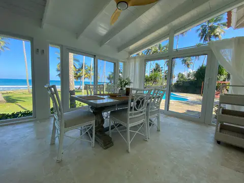 Dining table in the glassed sunroom with ocean views
