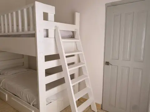 Bunk room with a white ladder