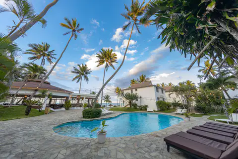 Pool and palm trees at Las Canas Beach Retreat
