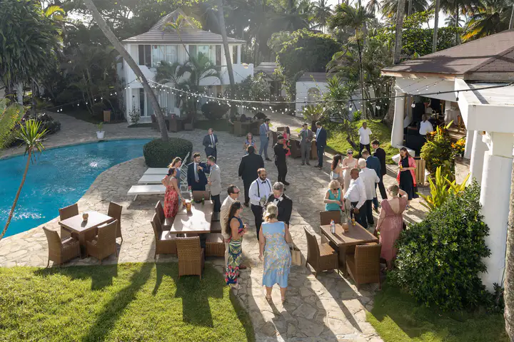 Guests gather beside the pool and garden at Las Canas