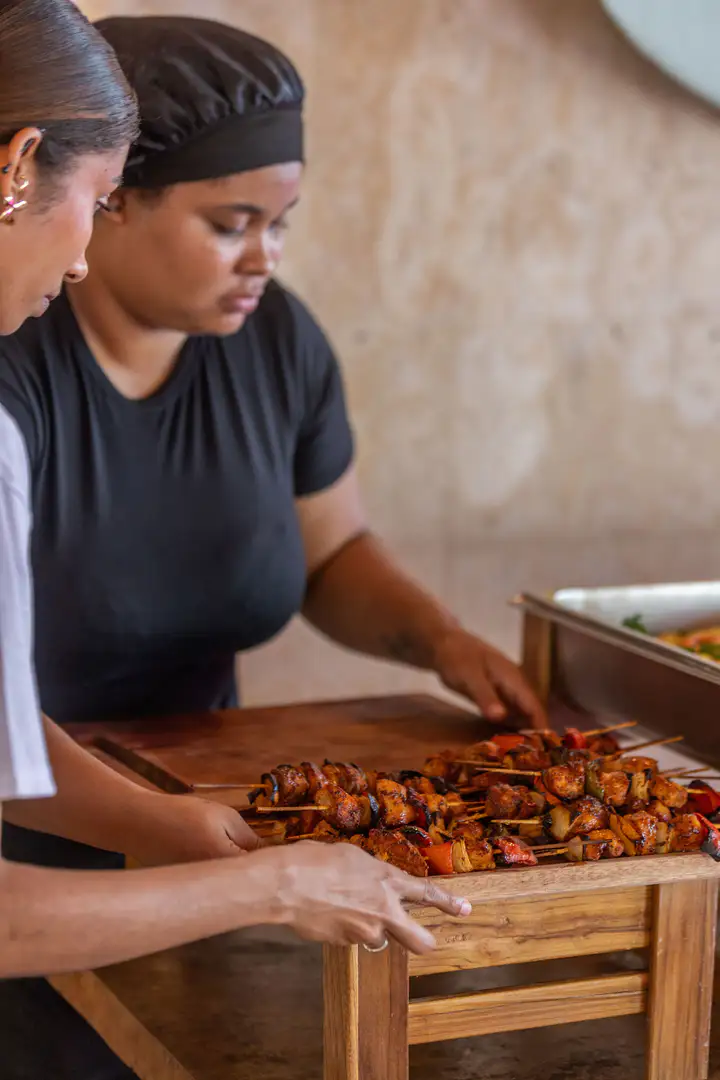 Chef preparing a tray of roasted food