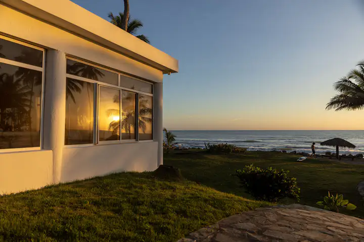 Beachfront villa glowing in the last light of sunset