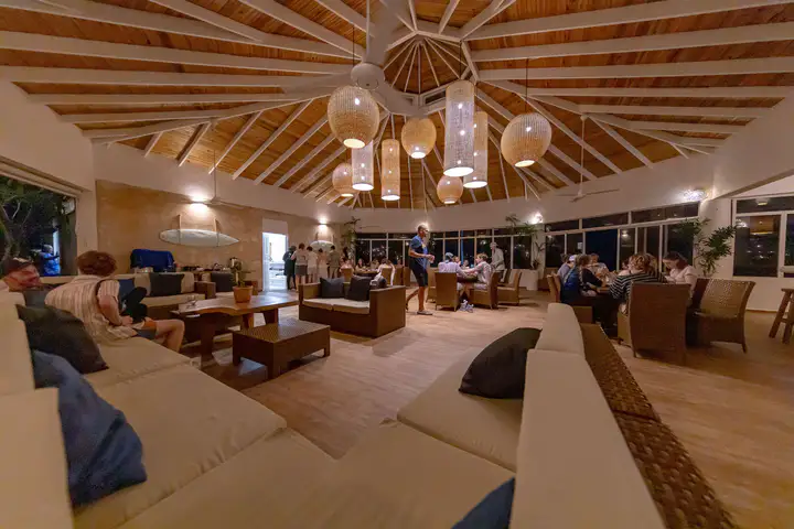 Restaurant interior with wooden tables and woven chairs